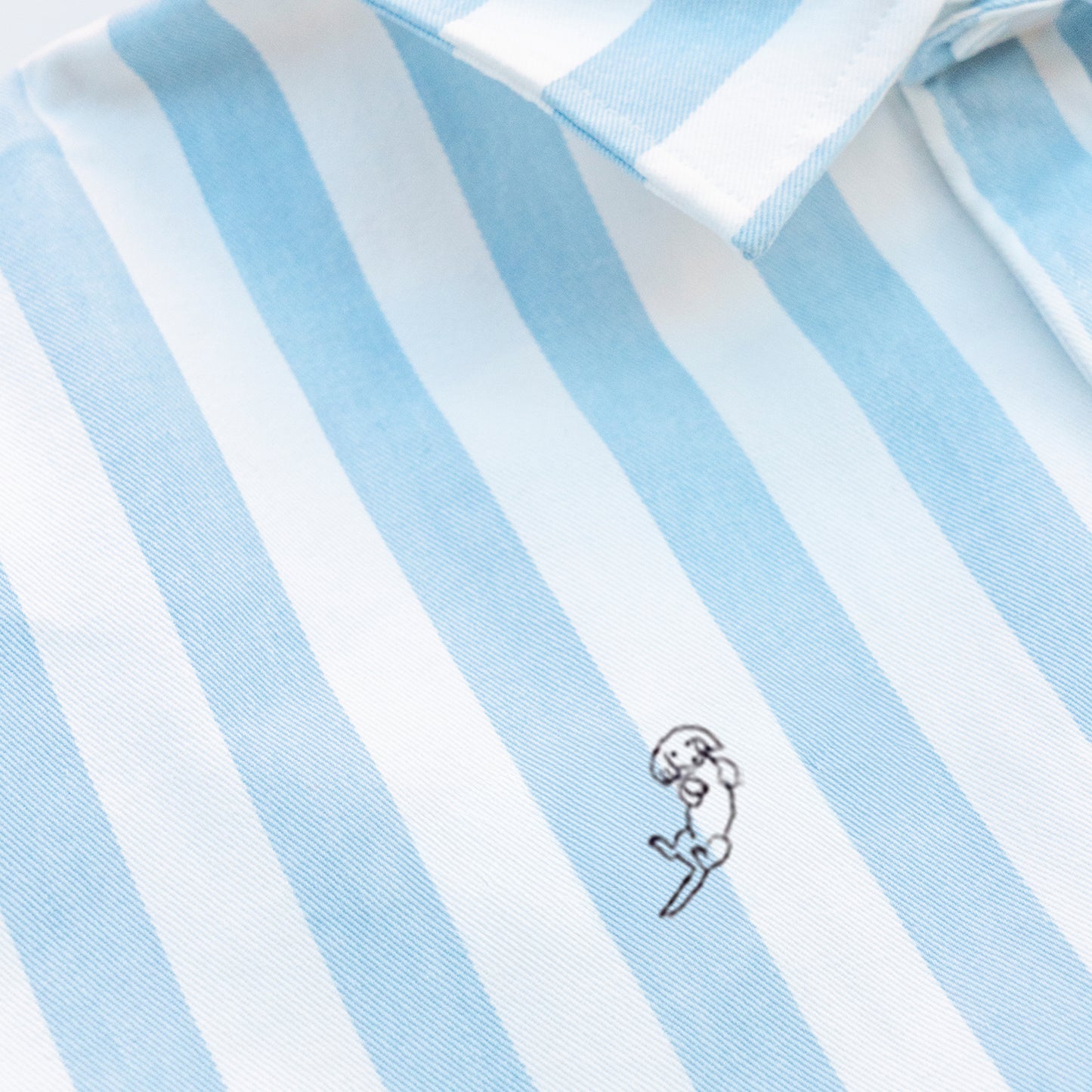 Woman wearing a striped shirt with a Long Hair Weiner Dog embroidery