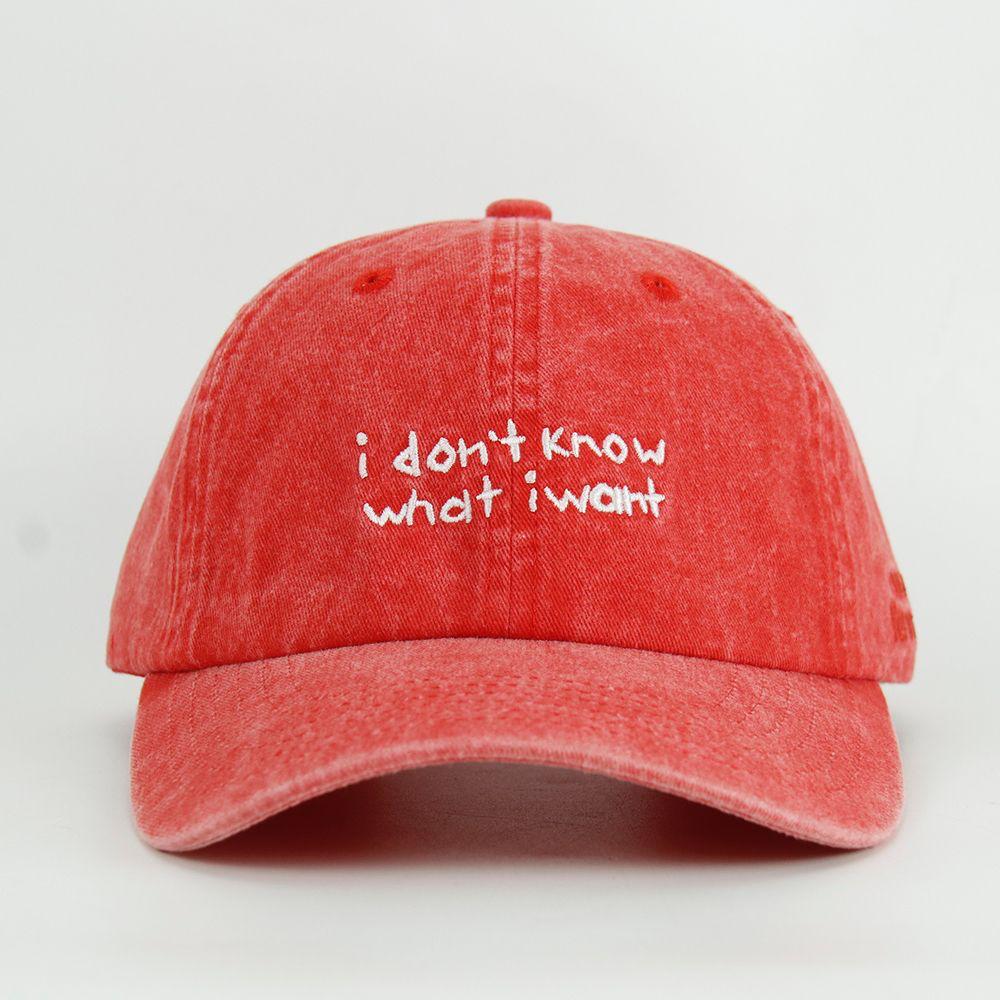 Red cap with 'i don't know what i want' text on a light gray background