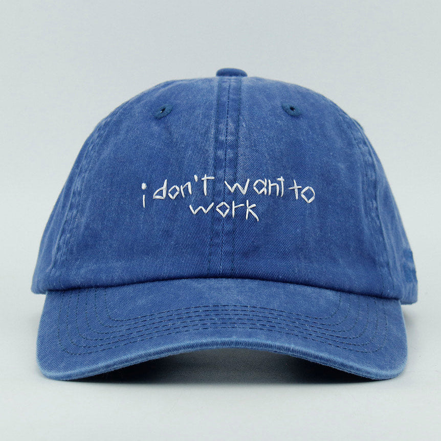 Blue cap with 'i don't want to work' embroidery text