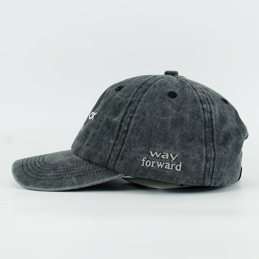 A washed black baseball cap with 'NEW YORK GIRL' embroidered in white on the front.