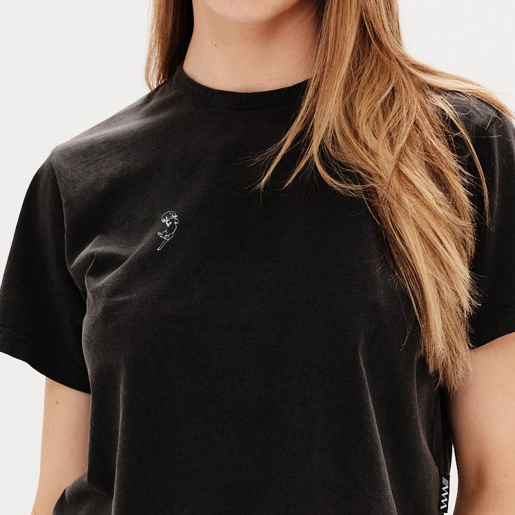 Woman wearing a black t-shirt with a long hair wiener dog embroidery