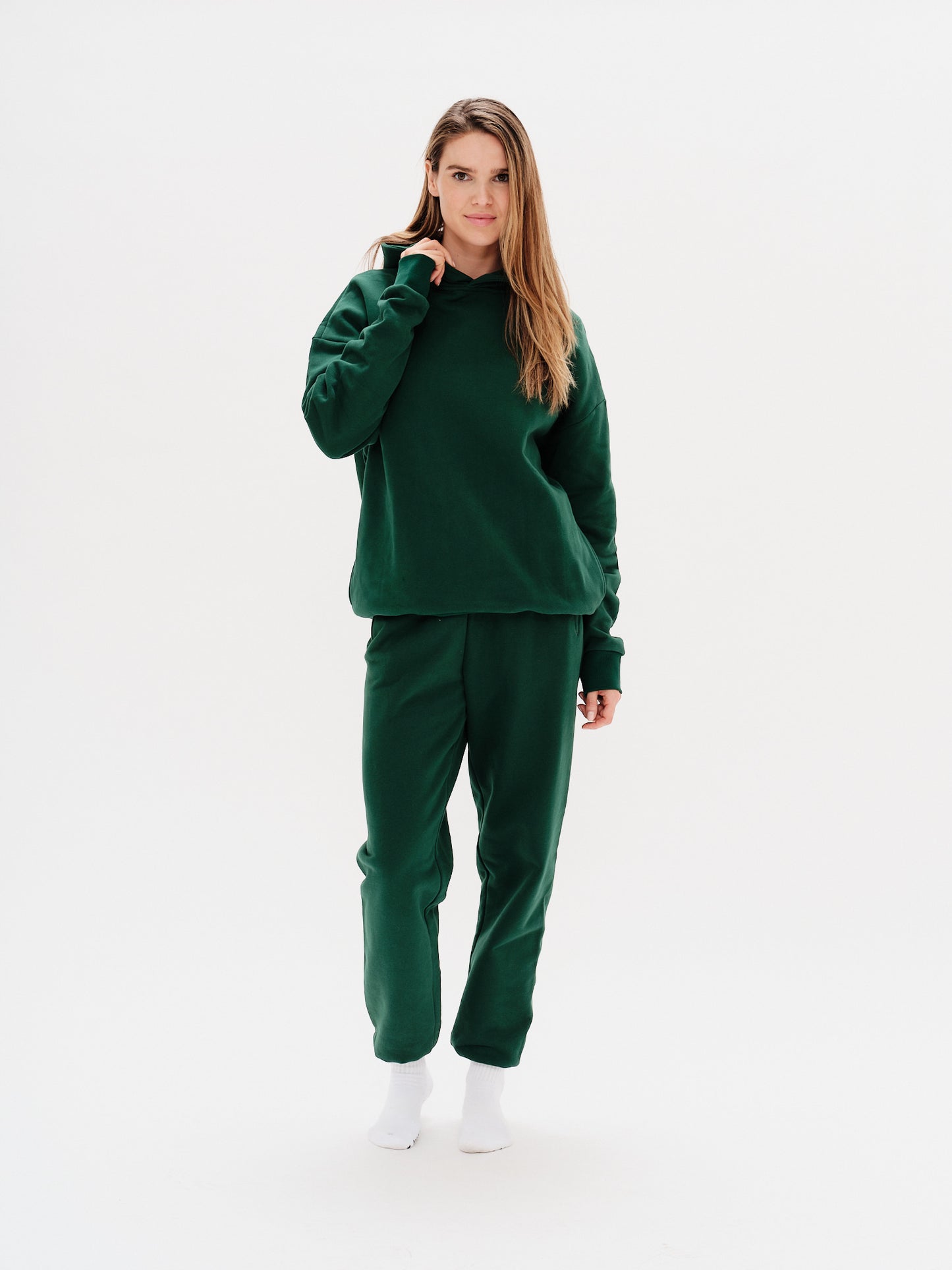 Woman wearing green pants with I'm Expensive embroidery