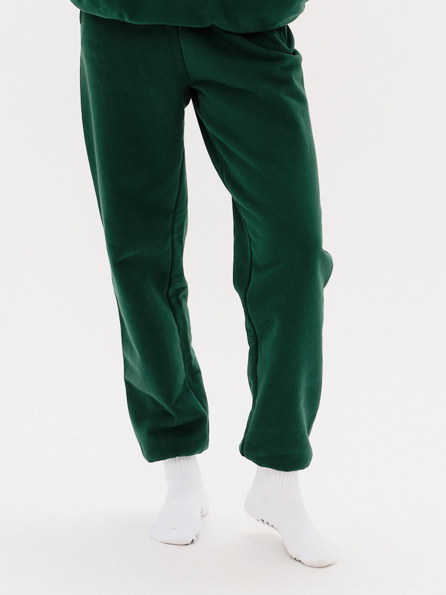 Woman wearing green pants with New York Boy embroidery