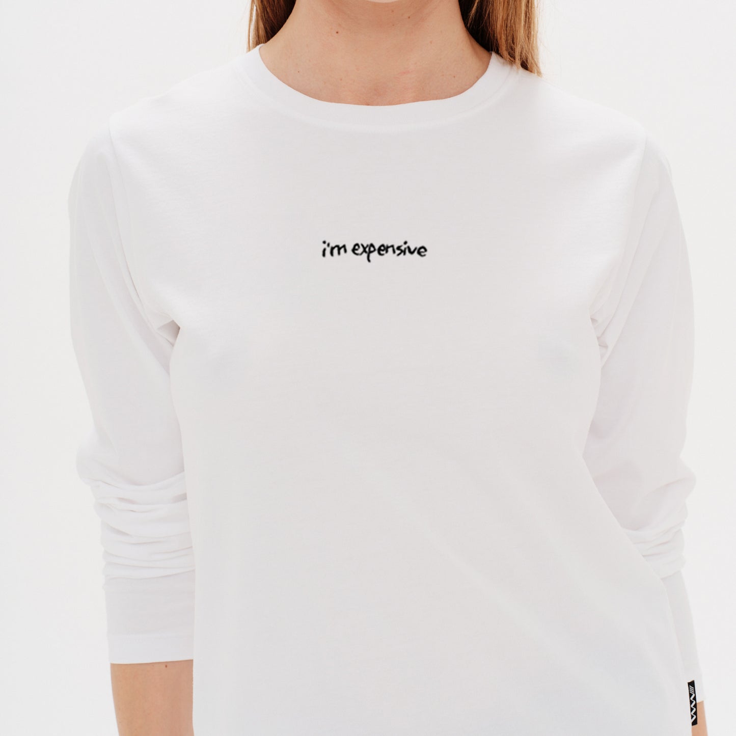 white t-shirt with i'm expensive embroidery