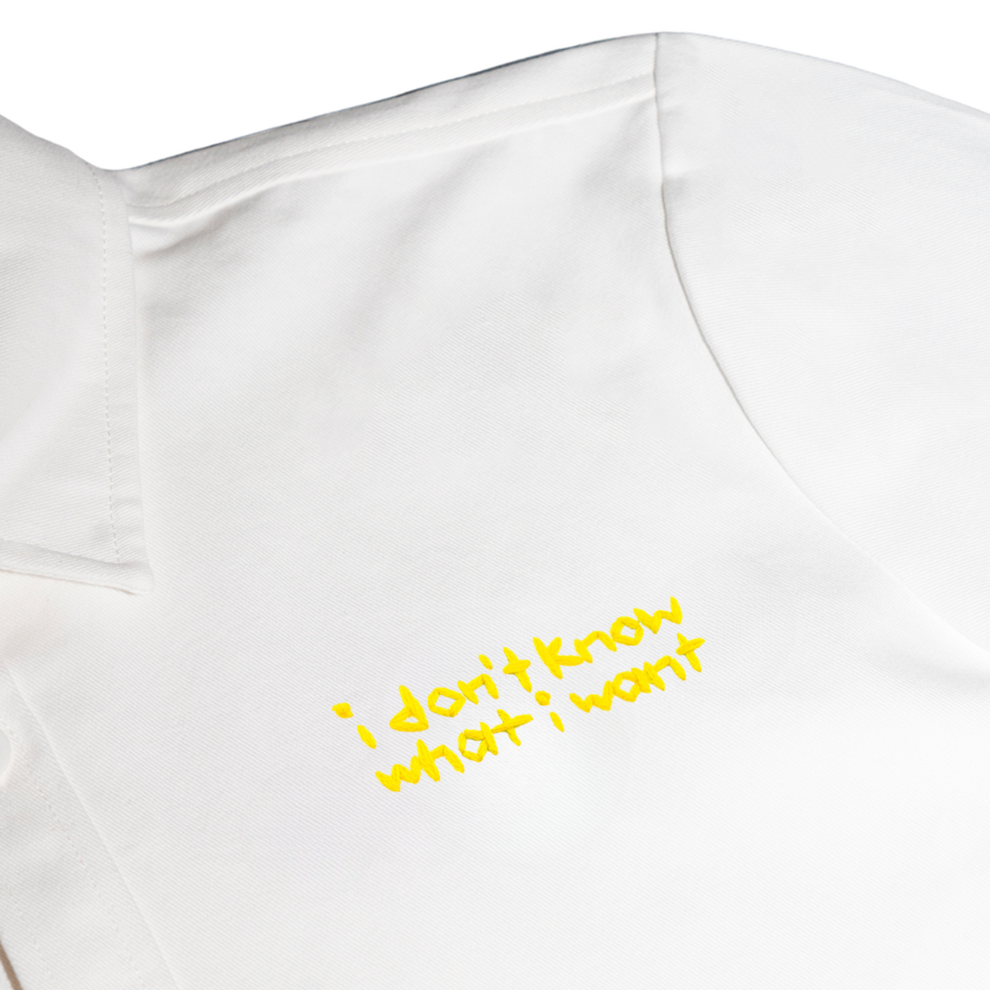 White shirt with yellow text 'i don't know what i want' on a white background