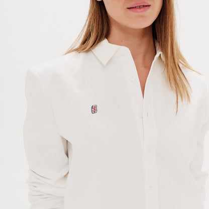 Woman wearing a white shirt with a Diet Coke embroidery