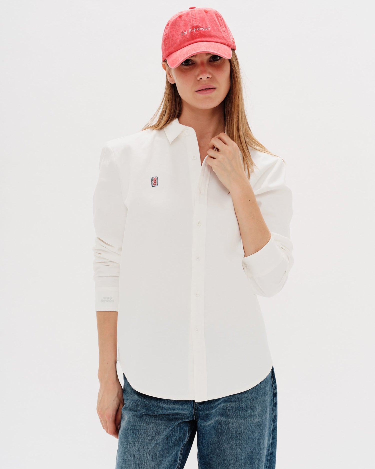 Woman wearing a white shirt with a Diet Coke embroidery