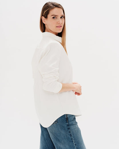 Woman wearing a white shirt with a Diet Coke embroidery