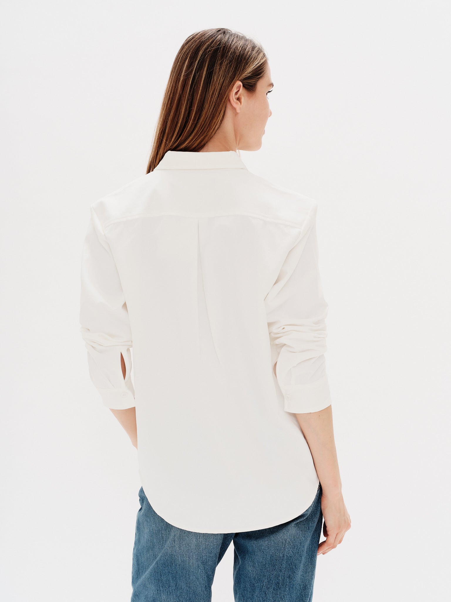 Woman wearing a white shirt with the duck embroidery