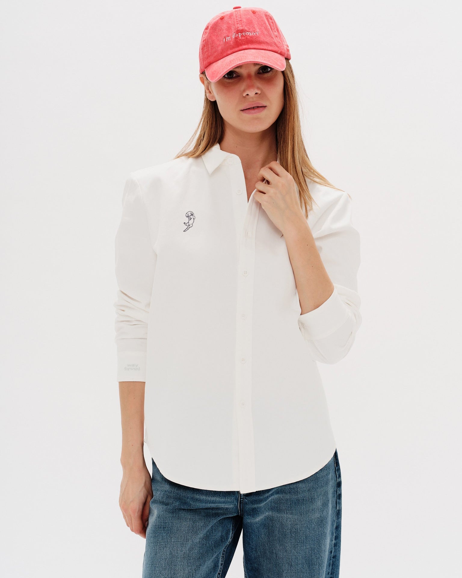 Woman wearing a white shirt with a Long Hair Weiner Dog embroidery