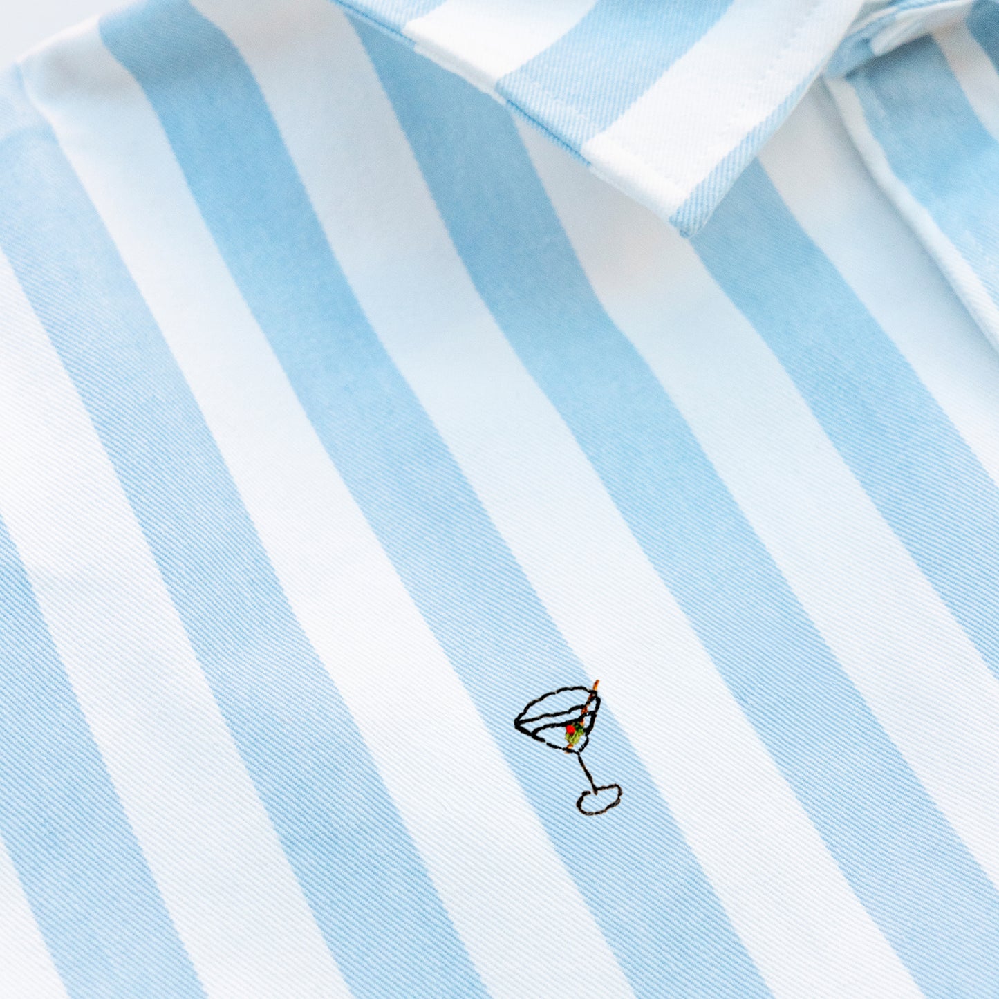 Woman wearing a striped shirt with a Martini embroidery