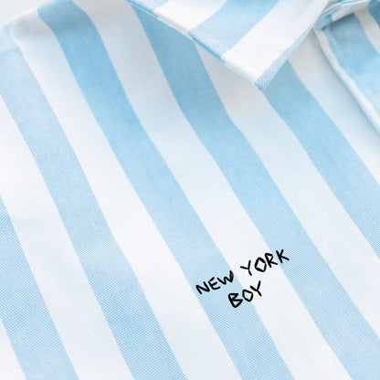 Woman wearing a striped shirt with a New York Boy embroidery