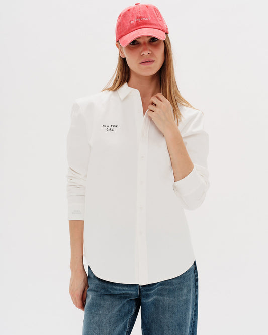 Woman wearing a white shirt with a New York Girl embroidery