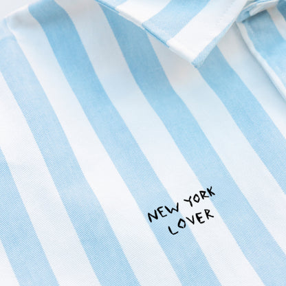 Woman wearing a striped shirt with a New York Lover embroidery
