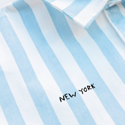 Woman wearing a striped shirt with a New York embroidery