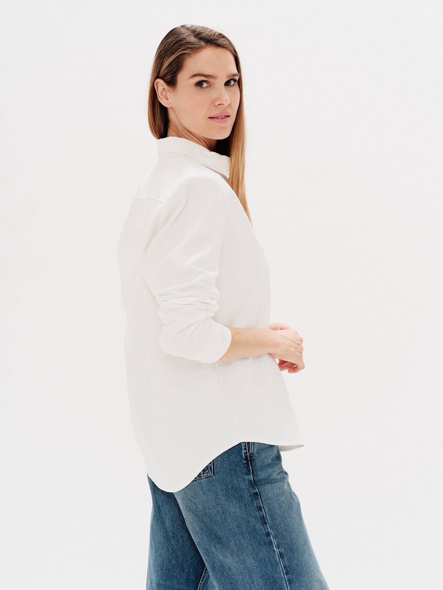 Woman wearing a white shirt with a Weiner Dog embroidery