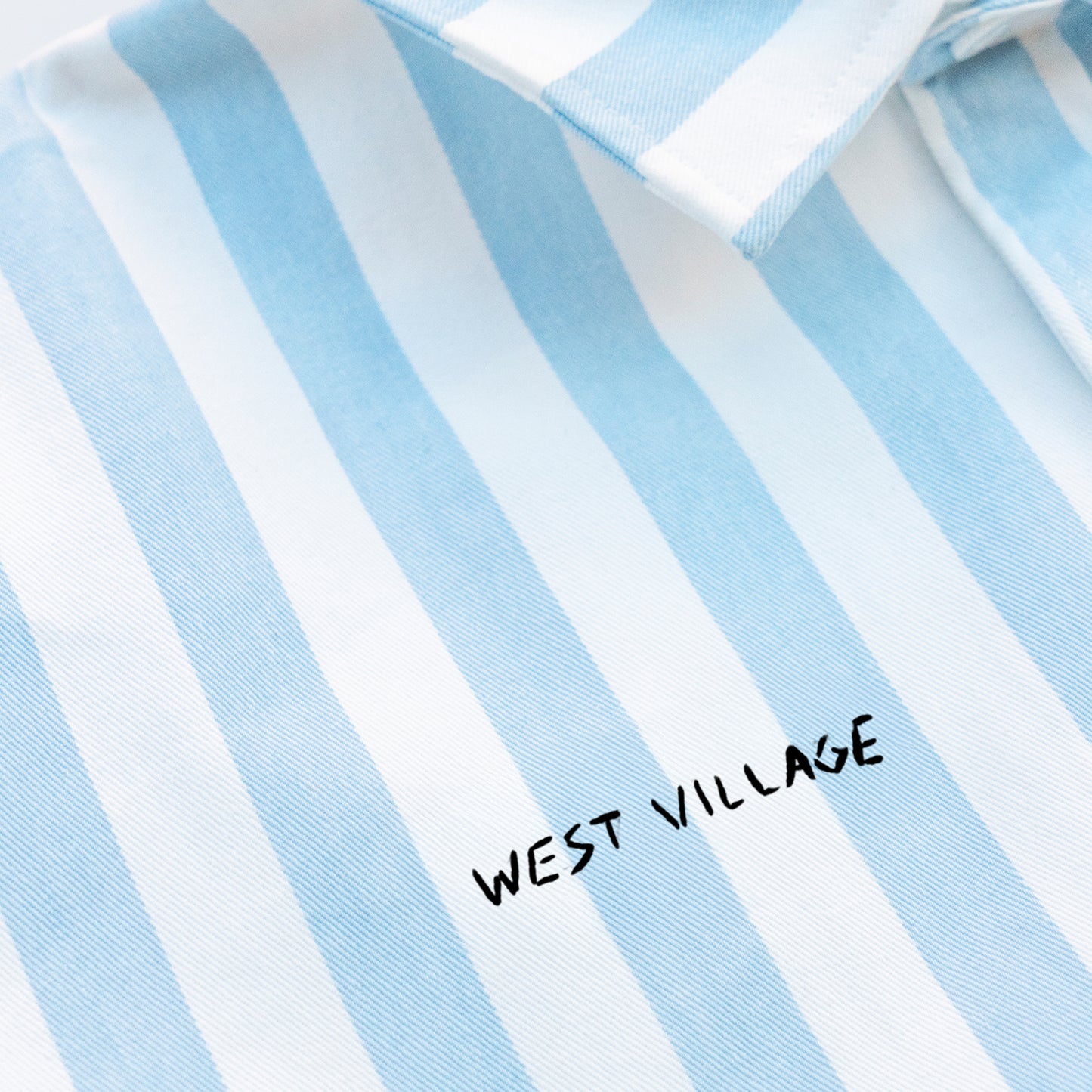 Blue and white striped shirt with West Village embroidery