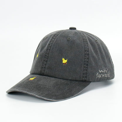 A black wash baseball cap with embroidered yellow duck designs on it, displayed against a plain background.