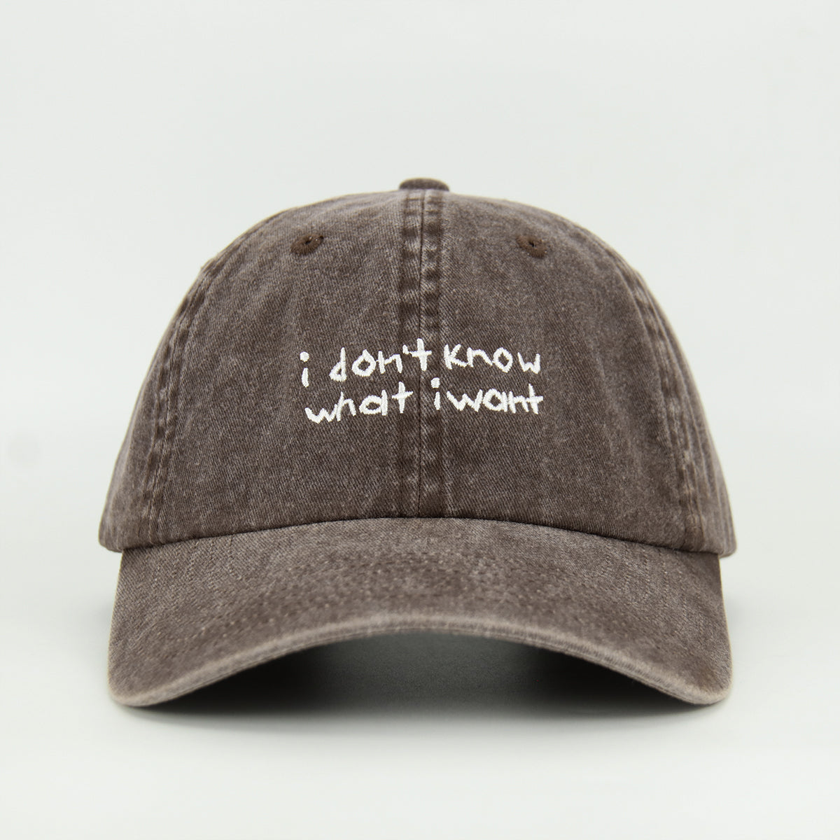 A brown baseball cap with the embroidered text 'i don't know what i want' in white.