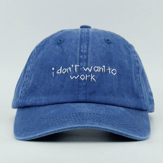 Blue cap with 'i don't want to work' embroidery text