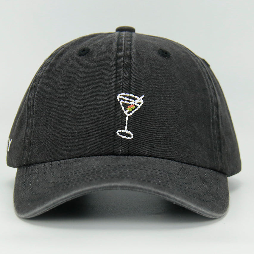 A black wash cotton baseball cap with a embroidered 'Martini' NY logo on the side, featuring an adjustable strap at the back.
