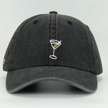 A black wash cotton baseball cap with a embroidered 'Martini' NY logo on the side, featuring an adjustable strap at the back.