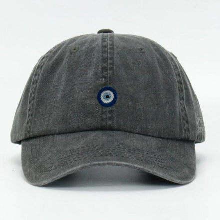 A black wash cotton baseball cap with a hand embroidered 'Nazar Eye' design on the front.