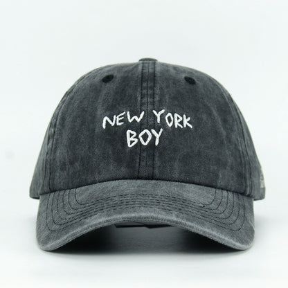 A black washed baseball cap with 'NEW YORK BOY' embroidered in white on the front.