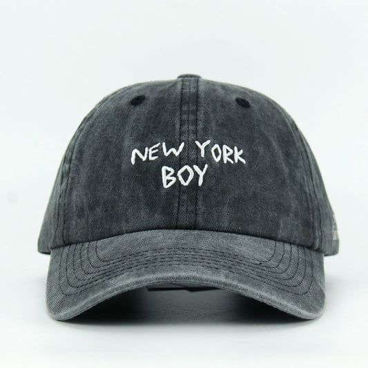 A black washed baseball cap with 'NEW YORK BOY' embroidered in white on the front.