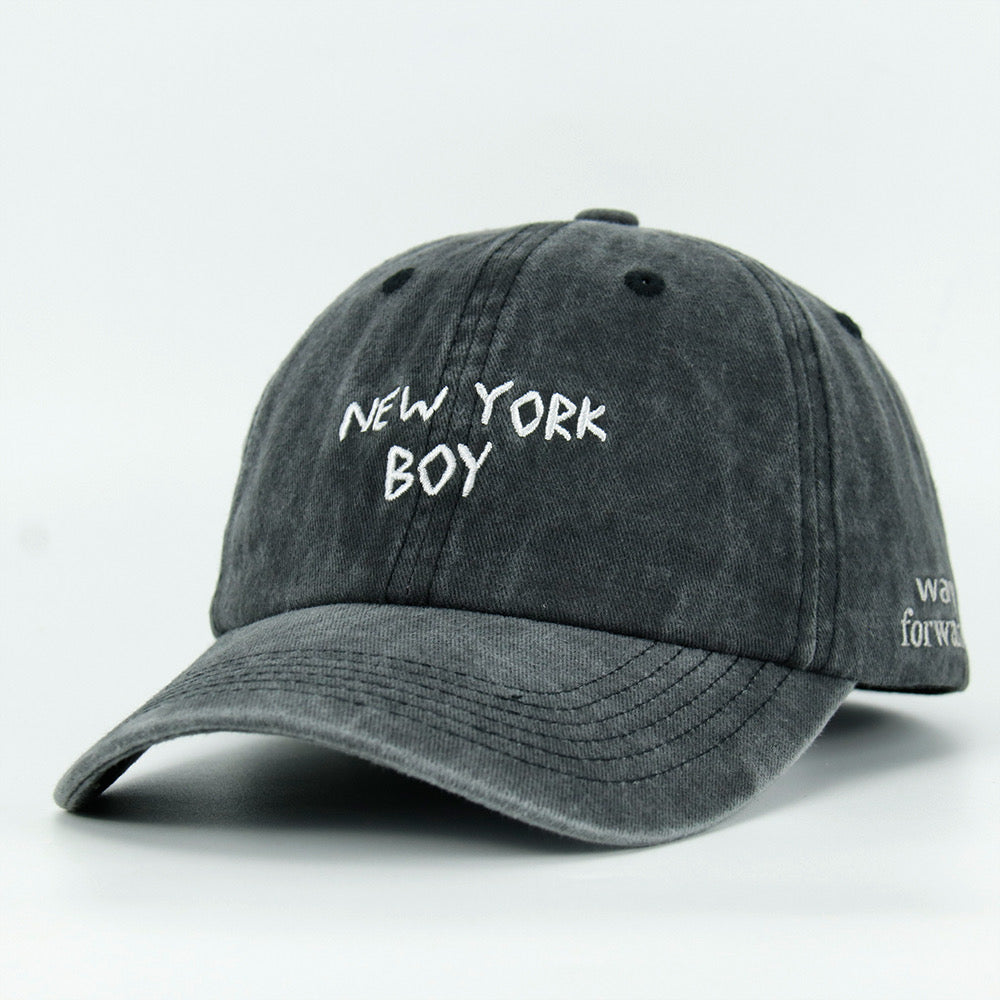 A black washed baseball cap with 'NEW YORK BOY' embroidered in white on the front.