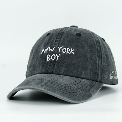 A black washed baseball cap with 'NEW YORK BOY' embroidered in white on the front.