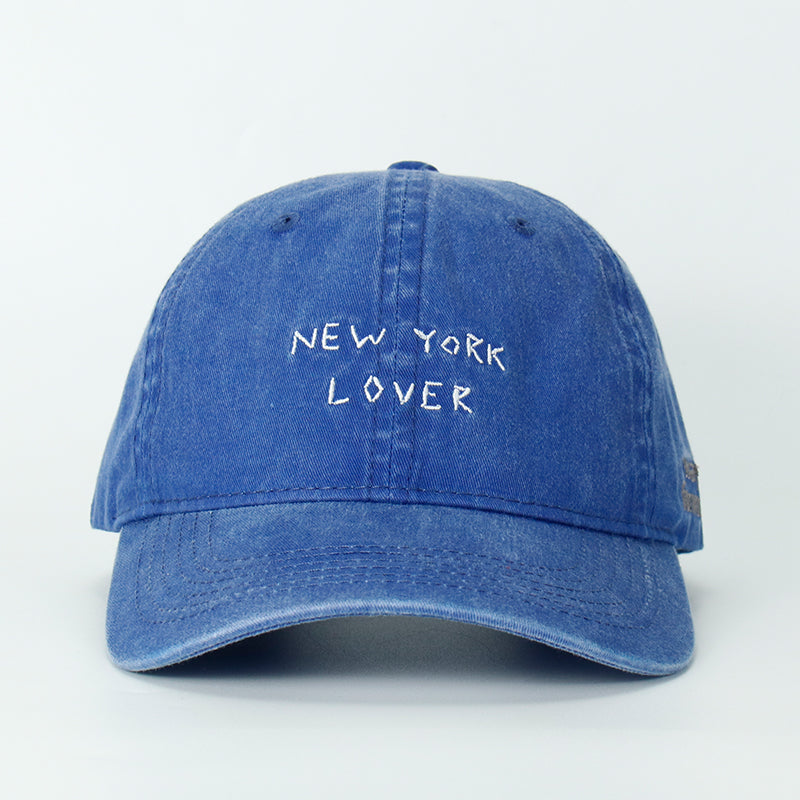 A blue whash baseball cap with 'NEW YORK LOVER' embroidered on the front.