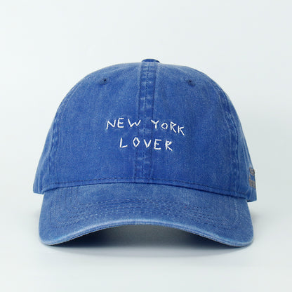 A blue whash baseball cap with 'NEW YORK LOVER' embroidered on the front.