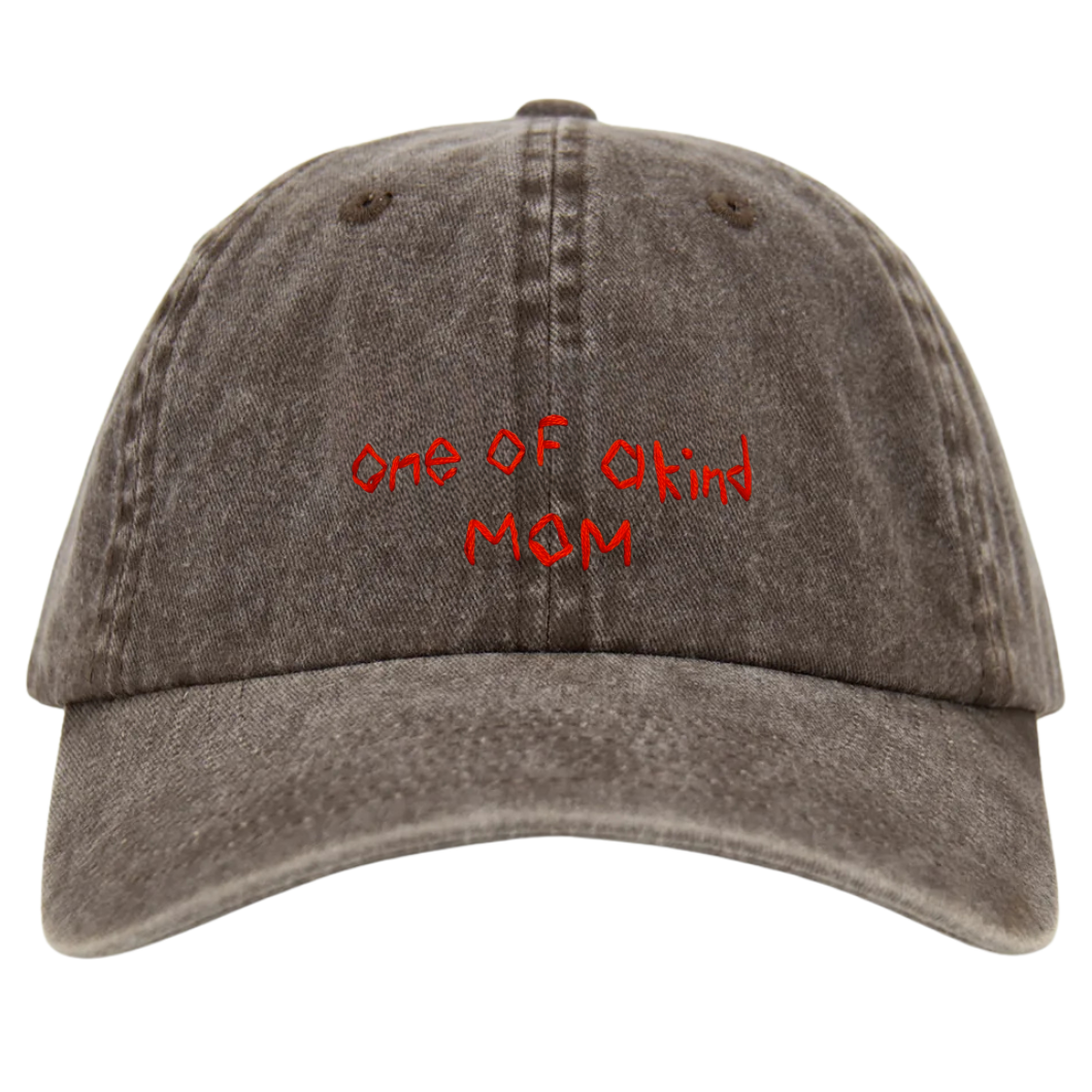A brown wash baseball cap with 'One of a Kind MOM' hand embroidered in red on the front.