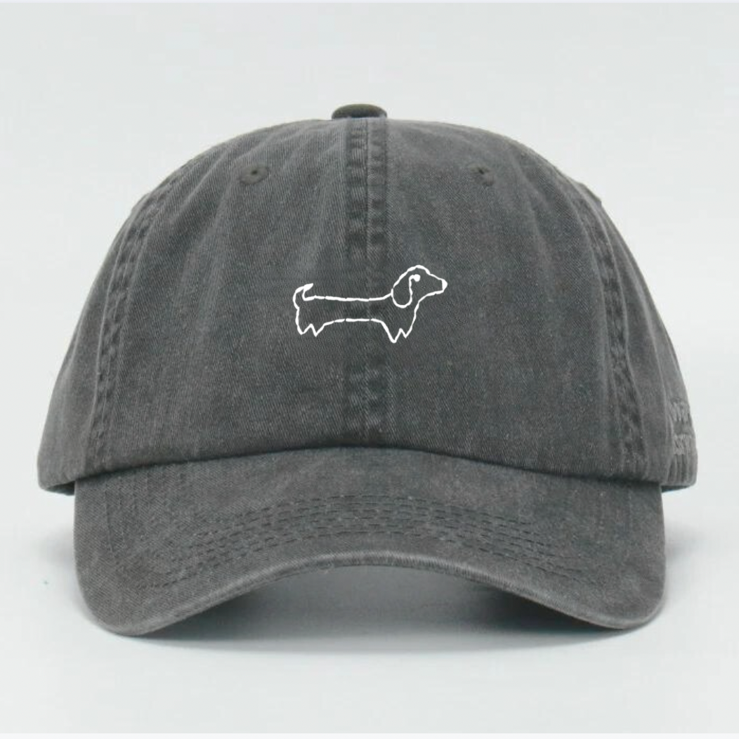 A washed black baseball cap with a hand embroidered white 'Wiener' feature on the front and an adjustable strap at the back.