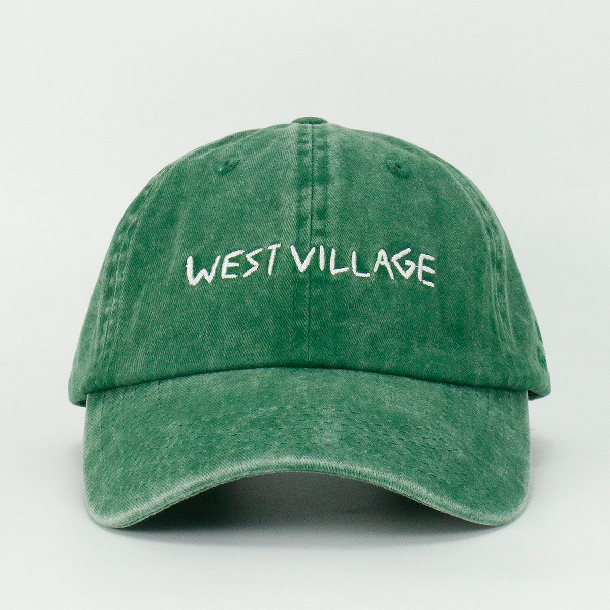 Green baseball cap with 'WEST VILLAGE' embroidered on the front.