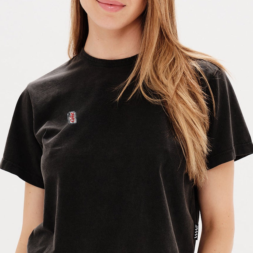 Woman wearing a black t-shirt with a diet coke embroidery