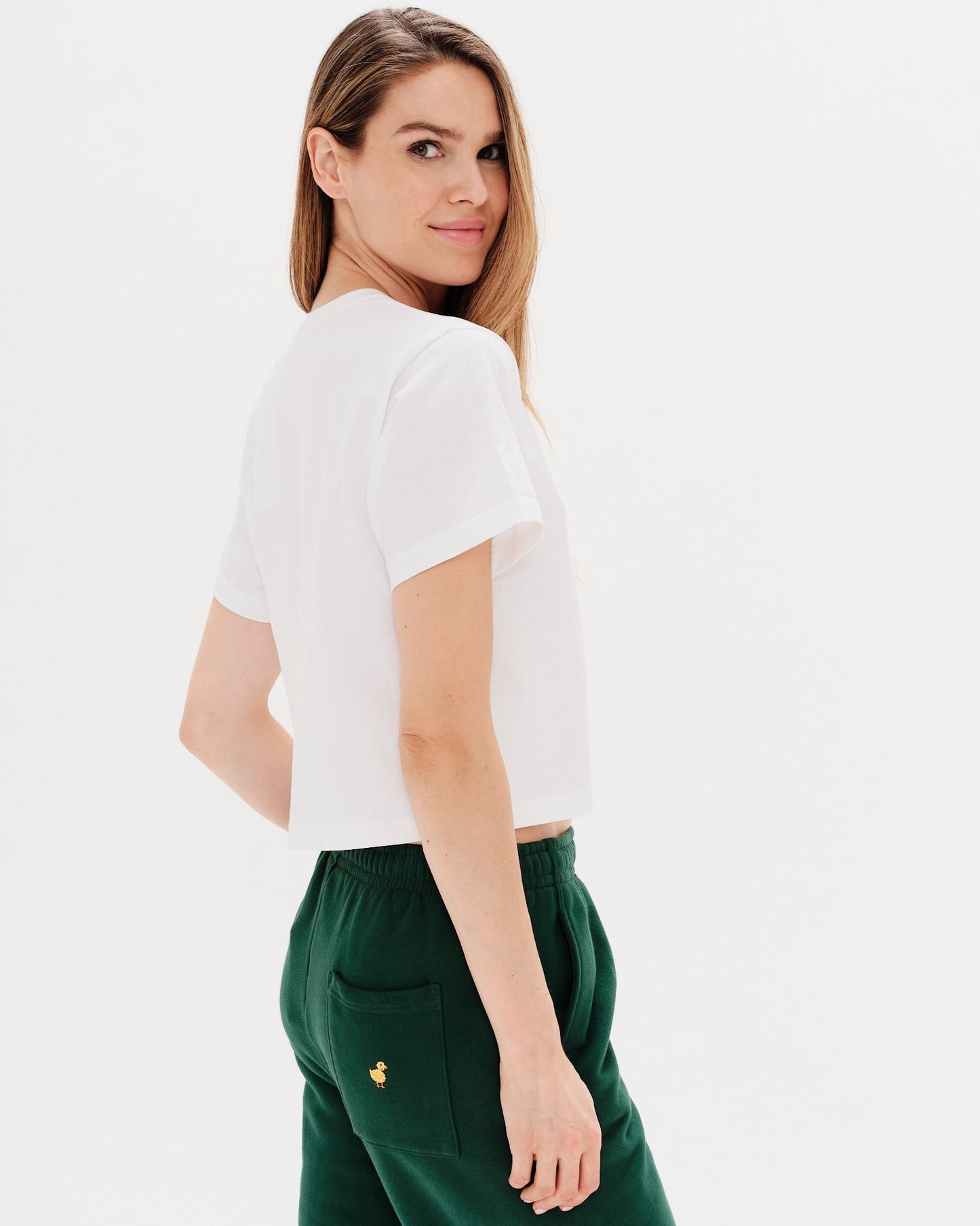 Woman wearing a white t-shirt with a diet coke embroidery