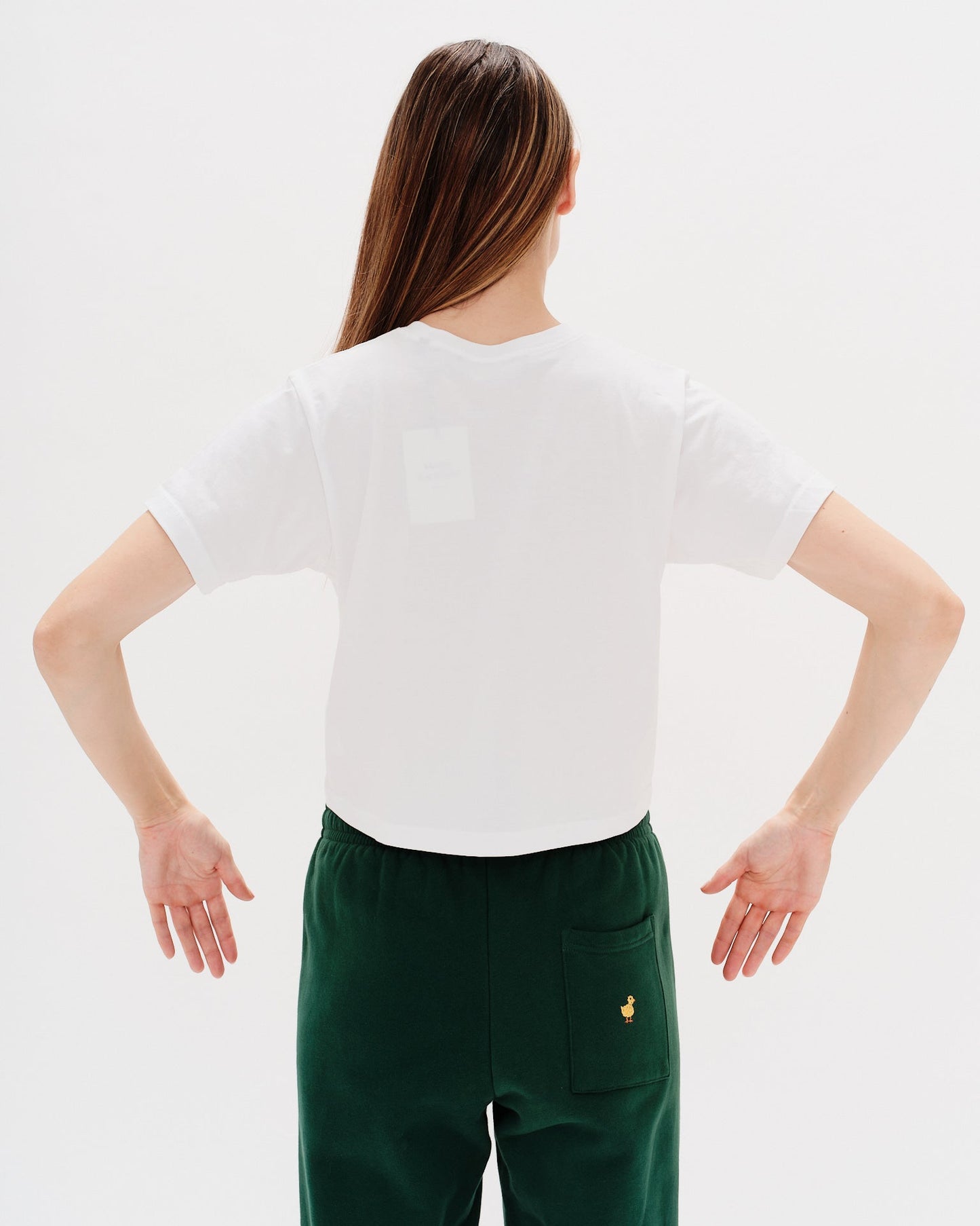 Woman wearing a white t-shirt with a diet coke embroidery