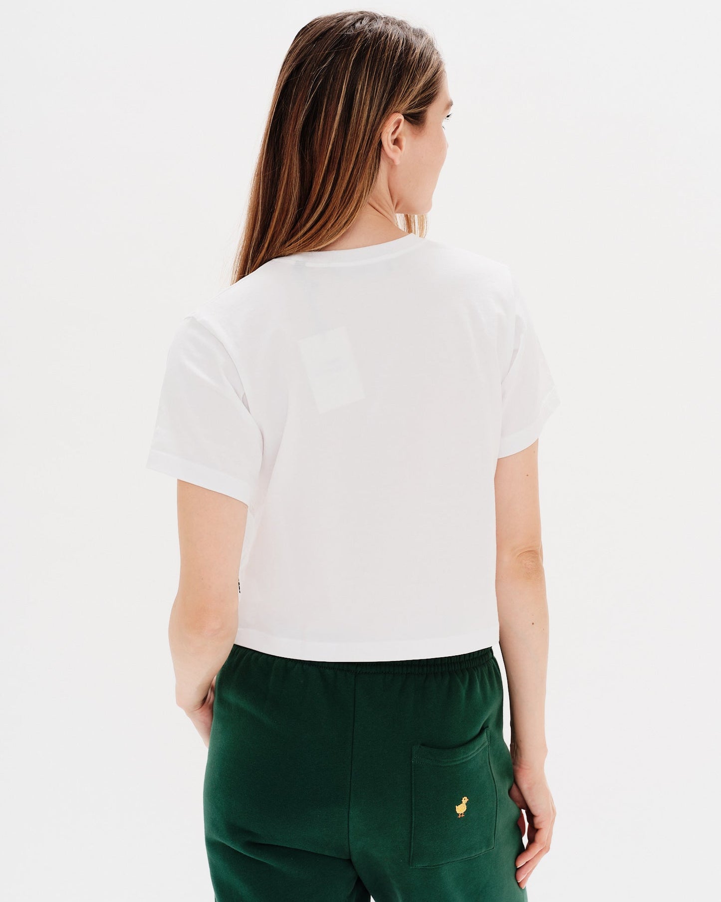 Woman wearing a white t-shirt with a diet coke embroidery