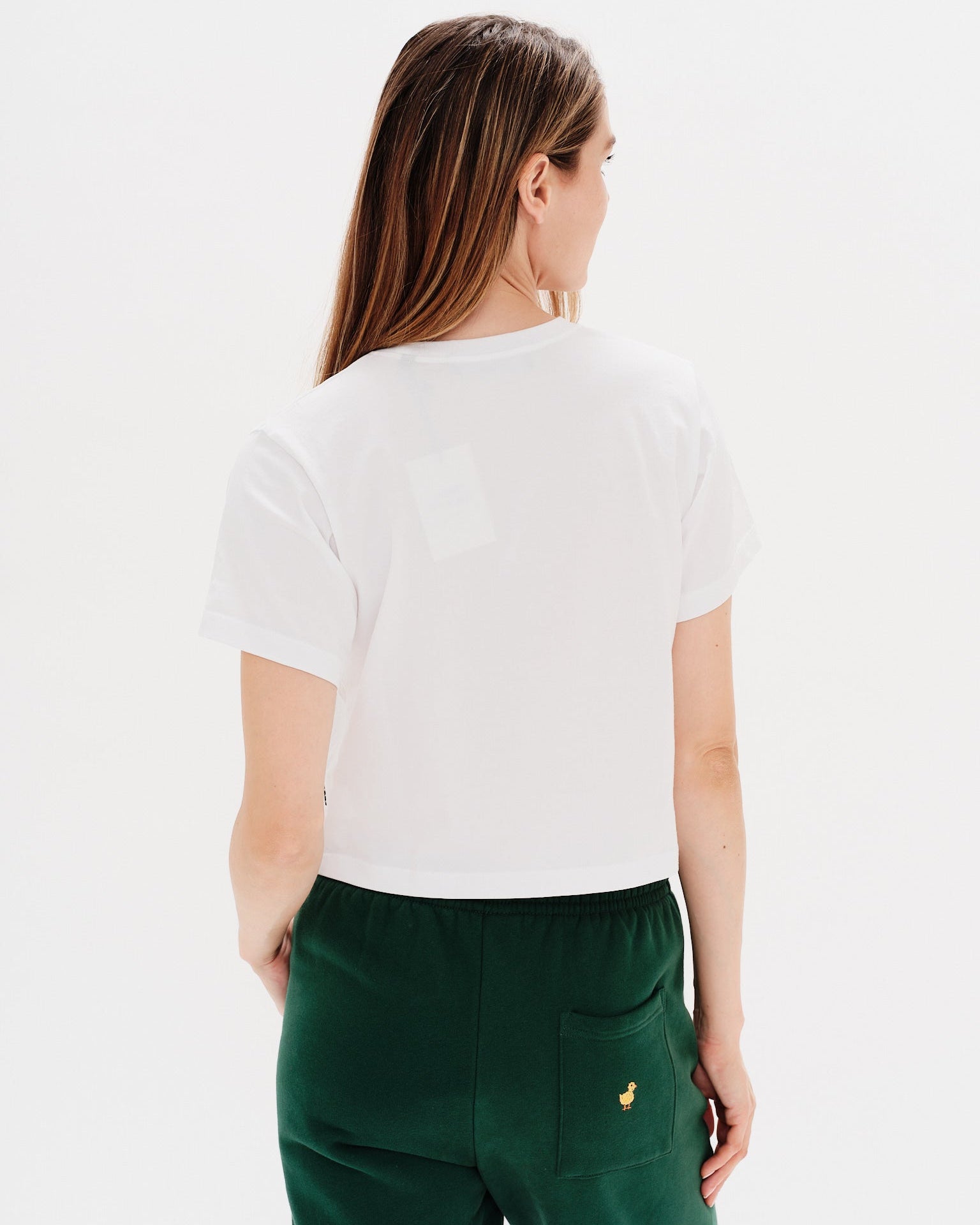 Woman wearing a white t-shirt with a diet coke embroidery