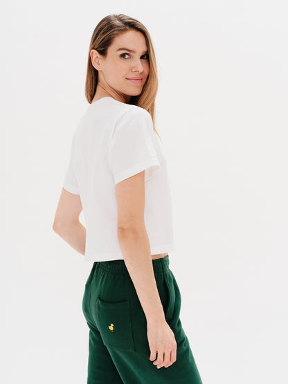 Woman wearing a white t-shirt with an I'm expensive embroidery