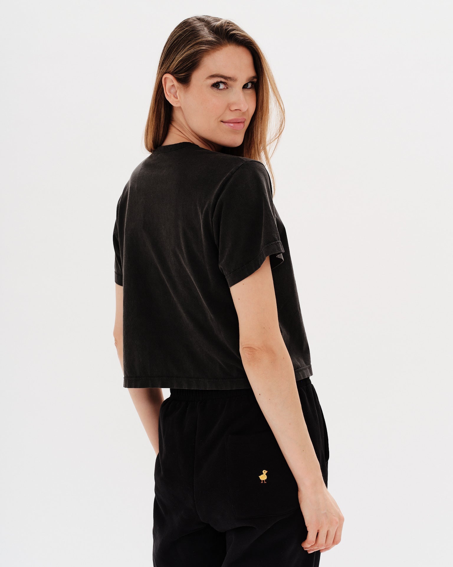 Woman wearing a black t-shirt with an I Don't Know What I Want embroidery