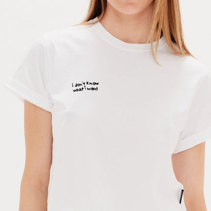 Woman wearing a white t-shirt with an I Don't Know What I Want embroidery