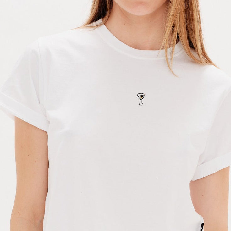 Woman wearing a white t-shirt with a martini embroidered design