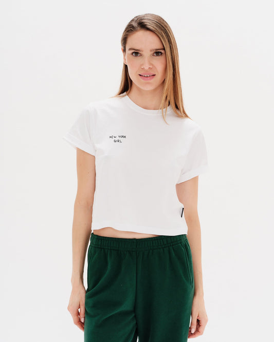 Woman wearing a white t-shirt with a New York Girl Embroidery