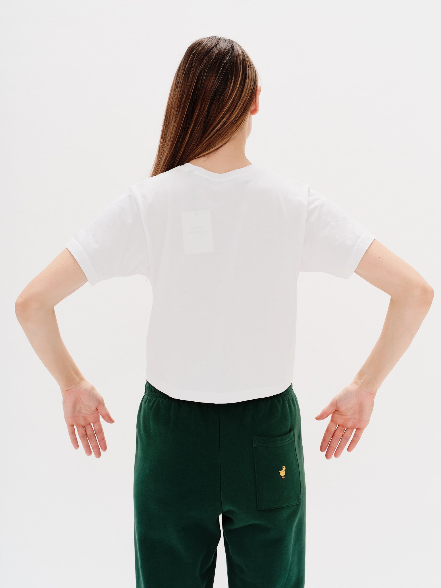 Woman wearing a white t-shirt with a New York Girl embroidery