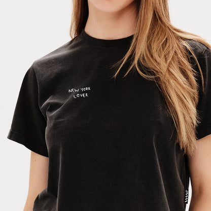 Woman wearing a black t-shirt with a New York Lover embroidery