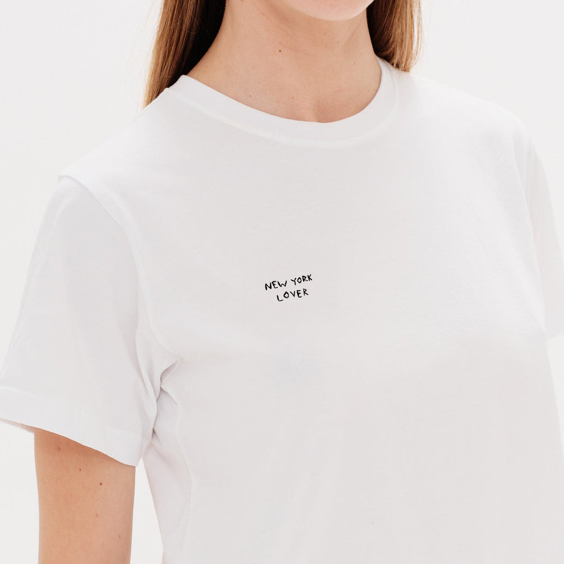 Woman wearing a white t-shirt with a New York Lover embroidery