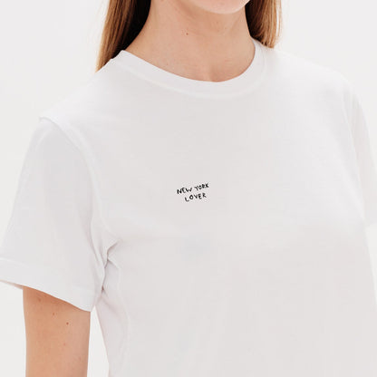 Woman wearing a white t-shirt with a New York Lover embroidery
